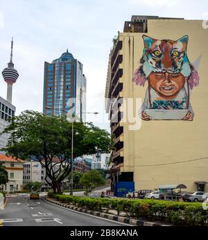 KL Tower Menara Olympia and a mural painted on the side of a building Kuala Lumpur Malaysia. Stock Photo