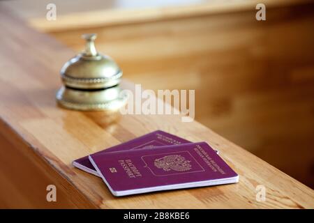 Close-up two russian passports at wooden reception desk Stock Photo