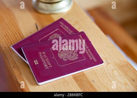 Close-up two russian passports at wooden reception desk Stock Photo