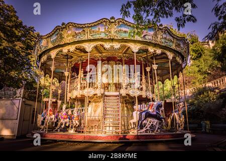 Traditional carousel fairground ride in Montmartre, Paris, France. Taken on a warm, golden Autumn morning in September Stock Photo