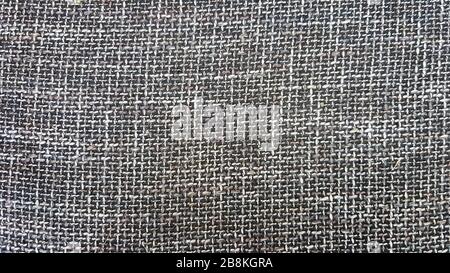 Close-up of gray fabric texture, background and wallpaper. The texture of the fabric is gray, textile upholstery. Gray tweed texture, gray wool Stock Photo
