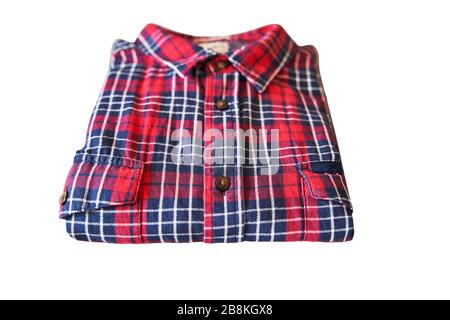 red checkered flannel shirt folded on a white isolated background Stock Photo