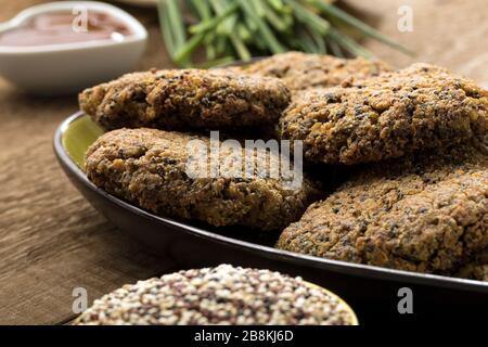 Gluten free and vegetarian quinoa hamburgers on a wooden table. Stock Photo