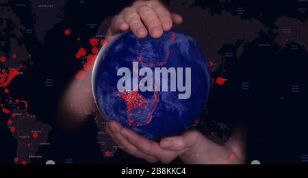Female hands hold the Earth in a medical protective mask against the starry sky during the epidemic Covid19 or coronavirus. Concept Stock Photo