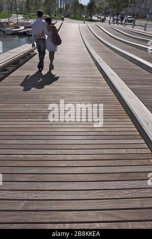 young couple walking on the boardwalk in waterfront, Toronto. Stock Photo