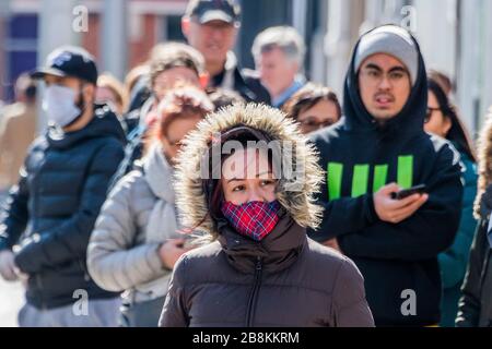 Some of the queue wear protective masks but there is still little sense that 'social distancing' is vital - Waitrose at Clapham Junction is only open to NHS workers and the over 70's for the first hour so a queue of regular customers waits outside - Anti Coronavirus (Covid 19) outbreak in London. Credit: Guy Bell/Alamy Live News Stock Photo