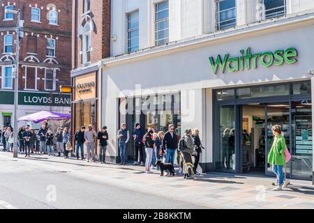 Some of the queue wear protective masks but there is still little sense that 'social distancing' is vital - Waitrose at Clapham Junction is only open to NHS workers and the over 70's for the first hour so a queue of regular customers waits outside - Anti Coronavirus (Covid 19) outbreak in London. Credit: Guy Bell/Alamy Live News Stock Photo