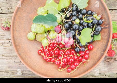 Plate of assortment berries raspberry, strawberry, blackberry mulberry Stock Photo