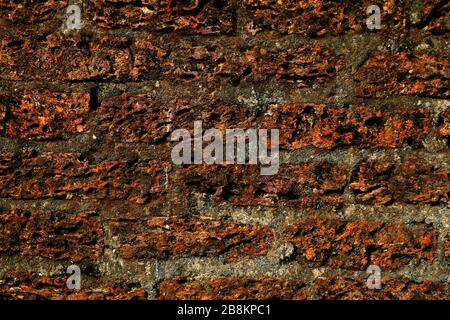 Old laterite wall laterite texture background,Pattern decorative uneven cracked real stone wall surface with cement Stock Photo