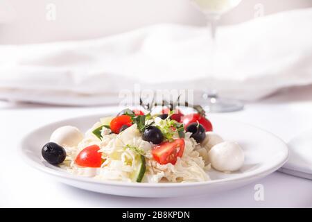 vegetables salad on the plate with assorted cheese, fruit and other snacks. Stock Photo