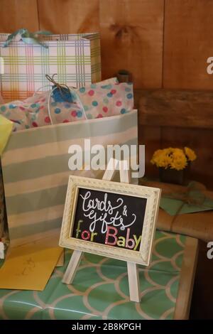 colorful gifts and cards on a table with sunflowers at a baby shower Stock Photo