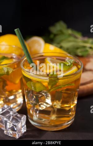 Two glasses of cold refreshment tea with ice and lemon fruit Stock Photo