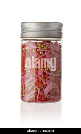 Full color topping sprinkle in glass bottle on isolated white background Stock Photo