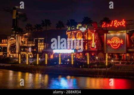 Orlando, Florida. February 12, 2020. Illuminated Hard Rock Cafe and Chocolate Emporium restaurant at Universals Citywalk Stock Photo