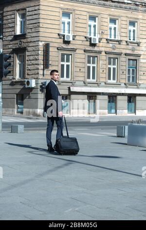 Portrait Of young Businessman  Outside Office. Meeting Concept. Man Walking and drinking coffe, going to the office. Stock Photo