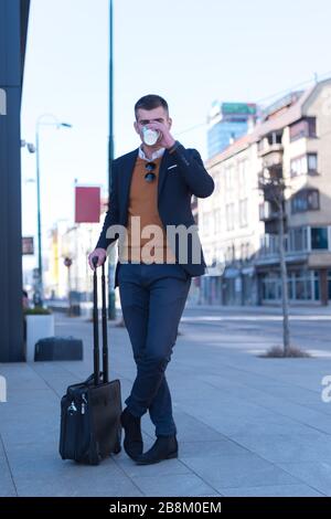 Portrait Of young Businessman  Outside Office. Meeting Concept. Man Walking and drinking coffe, going to the office. Stock Photo