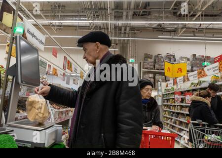 Moscow, Russia. 22nd of March, 2020 A customer makes purchases at a food store of the AUCHAN retail chain in the MEGA shopping center in Khimki, Russia Stock Photo
