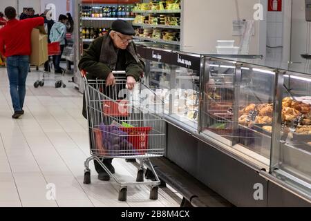 Moscow, Russia. 22nd of March, 2020 A customer makes purchases at a food store of the AUCHAN retail chain in the MEGA shopping center in Khimki, Russia Stock Photo