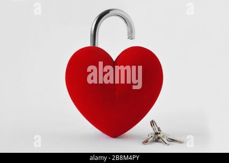 Open heart shaped padlock with keys on white background - Concept of love Stock Photo