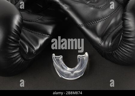 Boxing gloves and a mouth guard on a black background. sports product photography Stock Photo