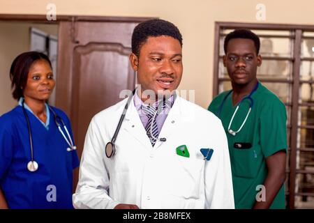 a team of doctors standing in a room ready for work. Stock Photo