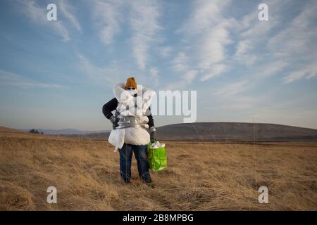 Perthshire Hills, UK. 22nd Mar, 2020. Pictured: Concept picture of a person going to extreme lengths to self isolate in the middle of nowhere carrying the most sought after item in the world of toilet paper, whilst wrapped up in home made personal protective equipment. Credit: Colin Fisher/Alamy Live News Stock Photo