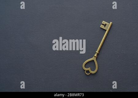Real estate, buy home concept , gold key on a black background . Stock Photo