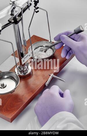 Pharmacist or scientist preparing medicine using precision weighing Stock Photo