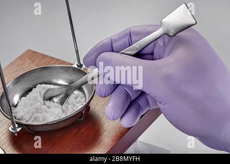 Pharmacist or scientist preparing medicine using precision weighing Stock Photo