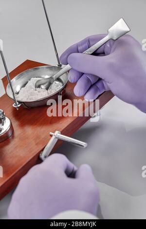 Pharmacist or scientist preparing medicine using precision weighing Stock Photo