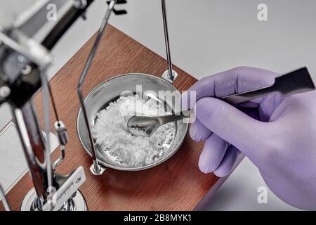 Pharmacist or scientist preparing medicine using precision weighing Stock Photo