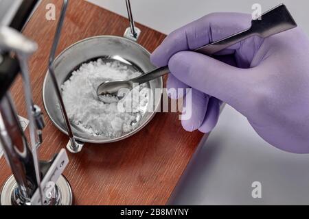 Pharmacist or scientist preparing medicine using precision weighing Stock Photo