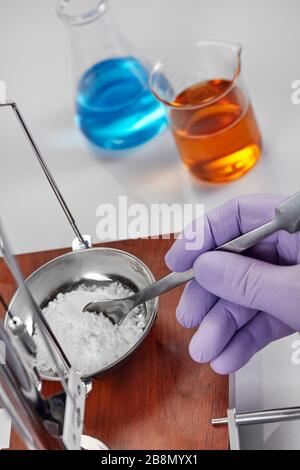 Pharmacist or scientist preparing medicine using precision weighing Stock Photo