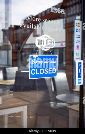 Sorry we are closed sign in shop door window Stock Photo