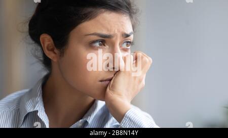 Close up depressed unhappy Indian woman thinking about problems Stock Photo