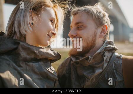 Portrait of couple in love in NBC protective suits. Concept of preventive measures and protection for coronavirus COVID 19 pandemic and other global d Stock Photo