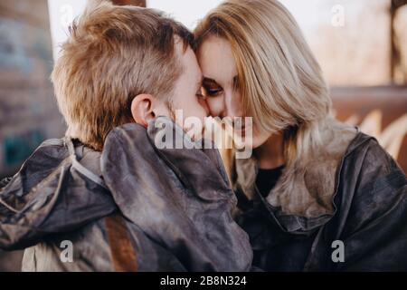 Portrait of couple in love in NBC protective suits and gloves. Concept of preventive measures and protection for coronavirus COVID 19 pandemic and oth Stock Photo