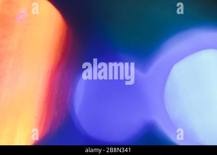 abstract lens flare on black background. blue and orange defocused bokeh lights. glowing color burst. bokeh abstract backdrop. Stock Photo