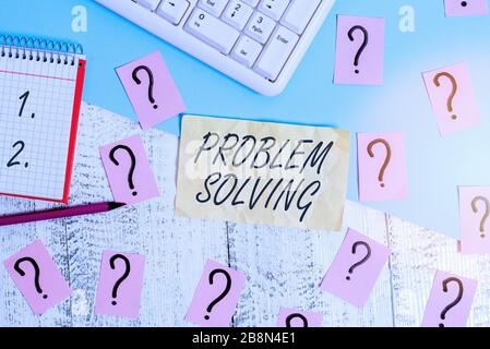 Writing note showing Problem Solving. Business concept for process of finding solutions to difficult or complex issues Writing tools and scribbled pap Stock Photo