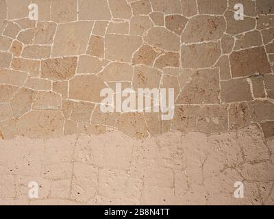 Cotrasts of medieval wall with renewal places. Stony wal from marble and sandstoen blocks. Medieval rotunda. Stock Photo