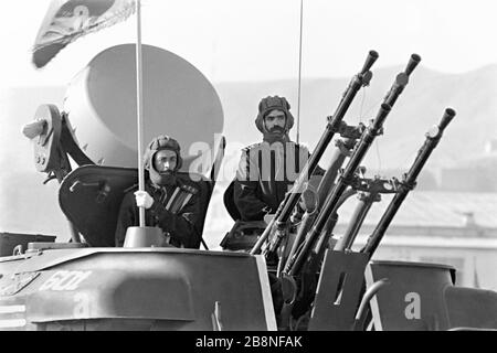 Afghan soldiers ride atop a Soviet-made ZSU-23-4 Shilka, a lightly armored self-propelled, radar guided anti-aircraft weapon system during a military parade to mark the tenth anniversary of the communist revolution April 26, 1988 in Kabul, Afghanistan. The communist regime took power in a revolt known as the Saur Revolution backed by the Soviet Union. Stock Photo