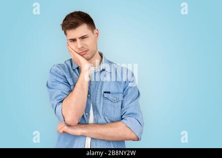 Young adult man making bored face looking at camera Stock Photo