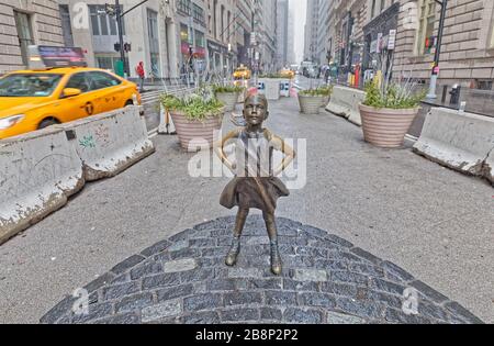 The Fearless Girl statue facing Charging Bull in Lower Manhattan New York Stock Photo