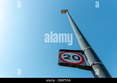 a close up view of a light post with a speed limit on it Stock Photo