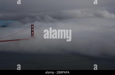 Golden Gate Bridge partially obscured by fog at dusk, San Francisco, California, United States, North America, color