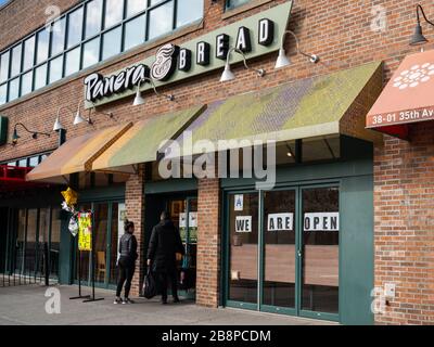 New York, New York, USA. 22nd Mar, 2020. New York, New York, U.S.: a couple enters a Panera Bread restaurant to pick up their order during the Coronavirus Outbreak in Queens. Credit: Corine Sciboz/ZUMA Wire/Alamy Live News