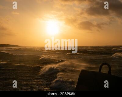 Beautiful sunset at Baltic Sea, storm at the sea, windy weather. Stock Photo