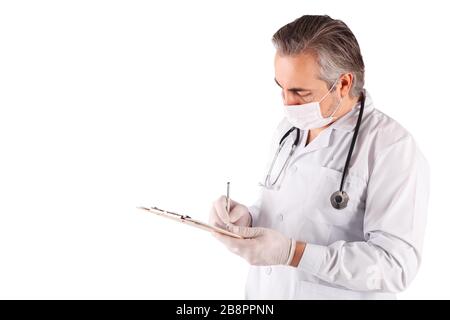 Close up of male doctor wearing mask and gloves, holding clipboard filling up medical form, isolated Stock Photo
