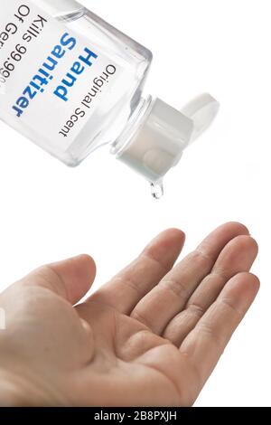Hand Sanitizer container applying alcohol based anti-viral sanitizer to patient's hand. Stock Photo