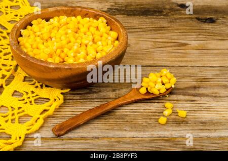 Sweet ripe canned corn in wooden bowl. Studio Photo Stock Photo